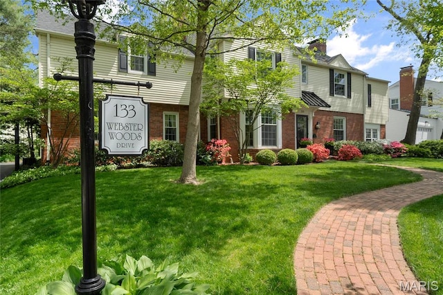 133 Webster Woods Dr, Saint Louis, MO 63119 - view of front facade featuring brick siding and a front yard