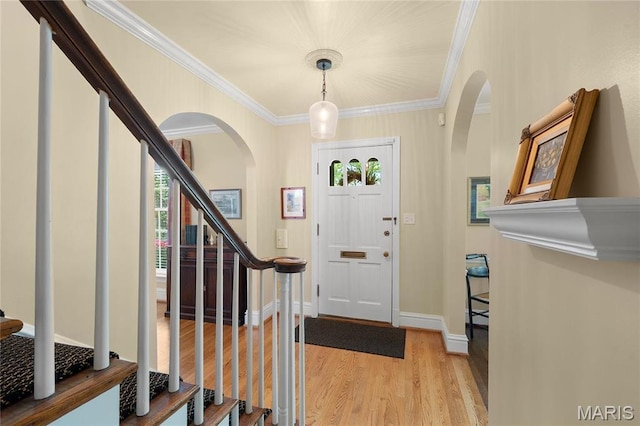 133 Webster Woods Dr, Saint Louis, MO 63119 - foyer entrance with arched walkways, light wood-style flooring, ornamental molding, stairs, and baseboards