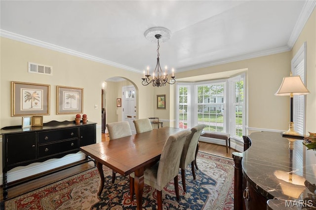 133 Webster Woods Dr, Saint Louis, MO 63119 - dining room with arched walkways, a chandelier, crown molding, and wood finished floors