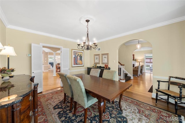 133 Webster Woods Dr, Saint Louis, MO 63119 - dining area featuring arched walkways, ornamental molding, wood finished floors, and a chandelier