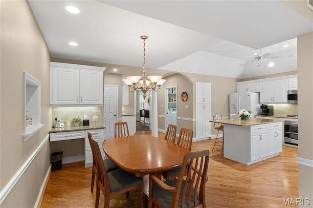 133 Webster Woods Dr, Saint Louis, MO 63119 - dining area featuring a chandelier, light wood-style flooring, ceiling fan, arched walkways, and recessed lighting