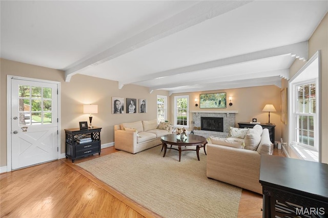 133 Webster Woods Dr, Saint Louis, MO 63119 - living area featuring beamed ceiling, wood finished floors, baseboards, and a brick fireplace