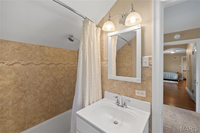 133 Webster Woods Dr, Saint Louis, MO 63119 - full bath with shower / bath combo with shower curtain, vanity, lofted ceiling, tile walls, and wood finished floors