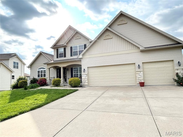 833 Harding St, Saint Peters, MO 63376 - view of front of home with driveway, a front lawn, an attached garage, a porch, and board and batten siding