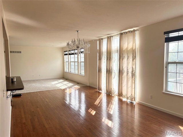 833 Harding St, Saint Peters, MO 63376 - unfurnished dining area featuring healthy amount of natural light, a chandelier, wood finished floors, and baseboards