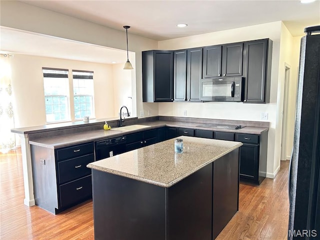 833 Harding St, Saint Peters, MO 63376 - kitchen featuring a sink, black appliances, light wood finished floors, a peninsula, and pendant lighting