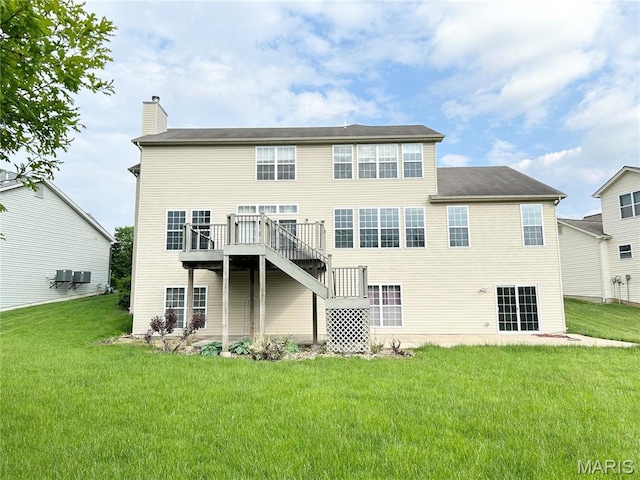 833 Harding St, Saint Peters, MO 63376 - back of property with a chimney, a yard, and a wooden deck