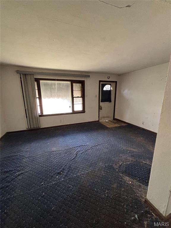 510 Ames Pl, Ferguson, MO 63135 - entrance foyer with dark colored carpet and baseboards