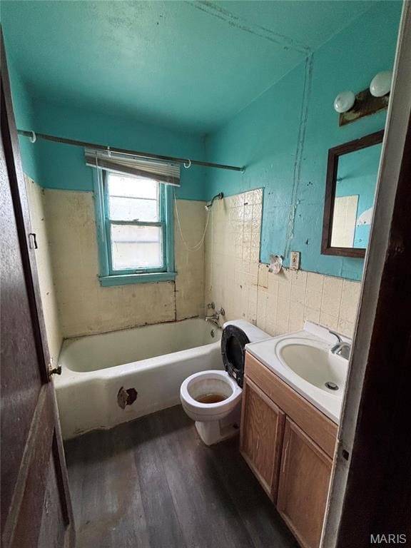 510 Ames Pl, Ferguson, MO 63135 - full bathroom featuring wood finished floors, tile walls, bathtub / shower combination, vanity, and toilet