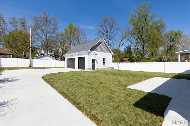 705 W Lockwood Ave, Glendale, MO 63122 - view of yard featuring an outdoor structure, a garage, concrete driveway, and a patio area