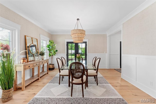 705 W Lockwood Ave, Glendale, MO 63122 - dining space with a chandelier, a wainscoted wall, light wood-style flooring, french doors, and ornamental molding