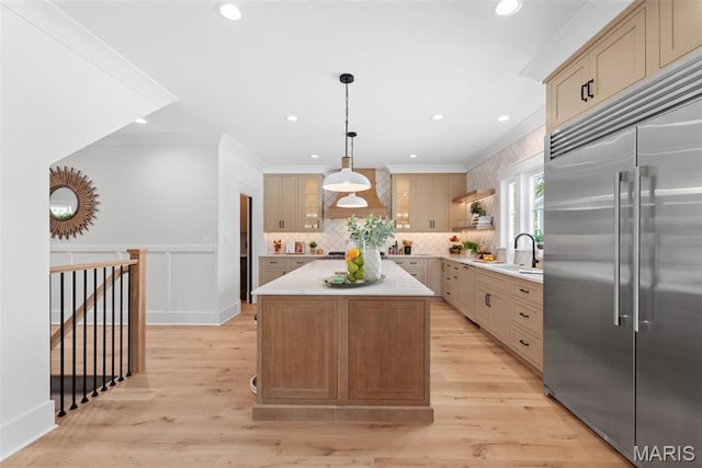 705 W Lockwood Ave, Glendale, MO 63122 - kitchen with stainless steel built in refrigerator, light countertops, decorative backsplash, a kitchen island, and pendant lighting