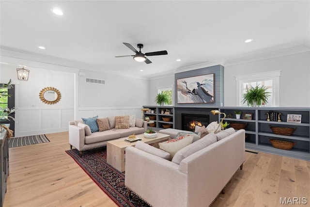 705 W Lockwood Ave, Glendale, MO 63122 - living area featuring crown molding, light wood finished floors, ceiling fan, a glass covered fireplace, and recessed lighting