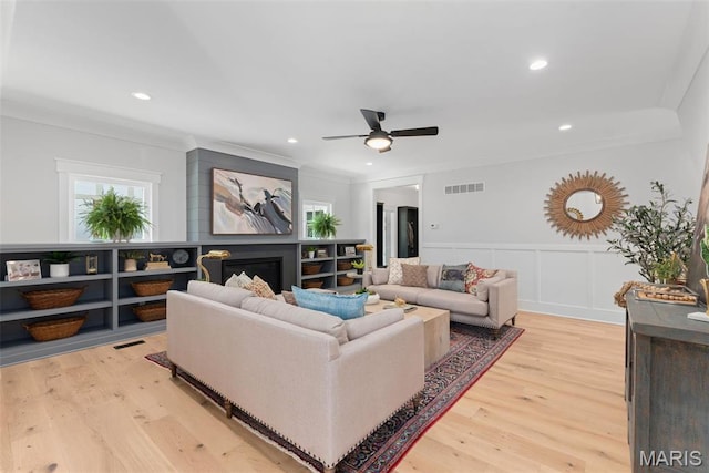 705 W Lockwood Ave, Glendale, MO 63122 - living area featuring a ceiling fan, light wood-style flooring, wainscoting, crown molding, and recessed lighting