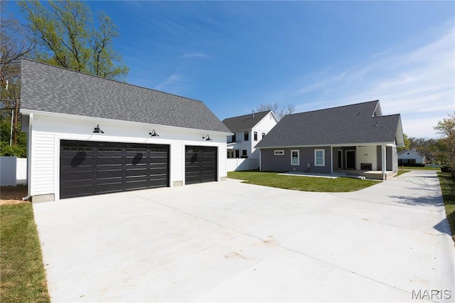 705 W Lockwood Ave, Glendale, MO 63122 - view of front of house with covered porch, concrete driveway, and roof with shingles