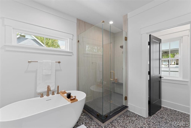 705 W Lockwood Ave, Glendale, MO 63122 - bathroom with plenty of natural light, a stall shower, a soaking tub, and baseboards