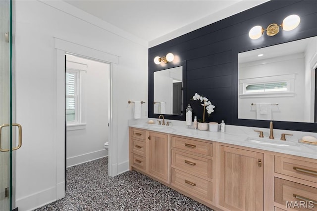 705 W Lockwood Ave, Glendale, MO 63122 - bathroom with toilet, plenty of natural light, double vanity, and baseboards