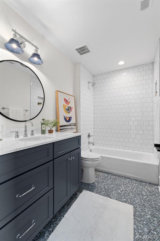 705 W Lockwood Ave, Glendale, MO 63122 - full bath featuring shower / tub combination, toilet, vanity, and tile patterned flooring