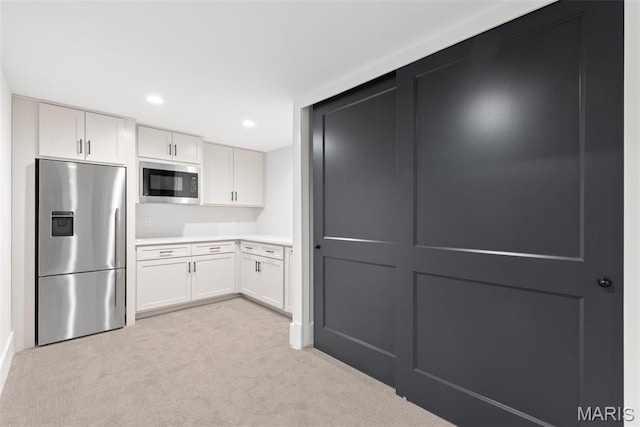 705 W Lockwood Ave, Glendale, MO 63122 - kitchen featuring stainless steel fridge with ice dispenser, built in microwave, light carpet, light countertops, and white cabinetry