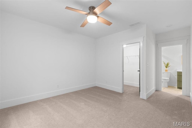 705 W Lockwood Ave, Glendale, MO 63122 - unfurnished bedroom featuring light carpet, a walk in closet, baseboards, a closet, and a ceiling fan