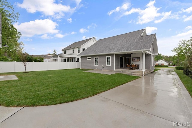705 W Lockwood Ave, Glendale, MO 63122 - back of property featuring a patio, driveway, and roof with shingles
