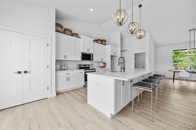 6345 Gibison Rd, Troy, MO 63379 - kitchen with appliances with stainless steel finishes, a sink, a chandelier, white cabinetry, and recessed lighting