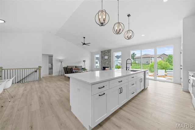 6345 Gibison Rd, Troy, MO 63379 - kitchen with a sink, a ceiling fan, a chandelier, light wood-type flooring, and a kitchen island with sink