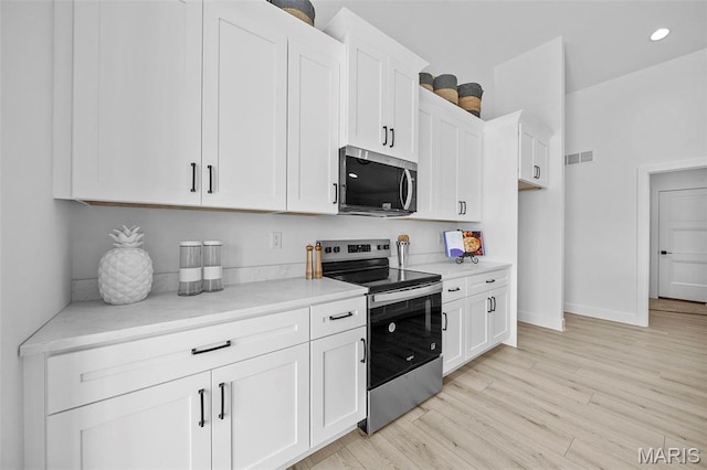 6345 Gibison Rd, Troy, MO 63379 - kitchen featuring appliances with stainless steel finishes, white cabinetry, light wood-style floors, baseboards, and recessed lighting