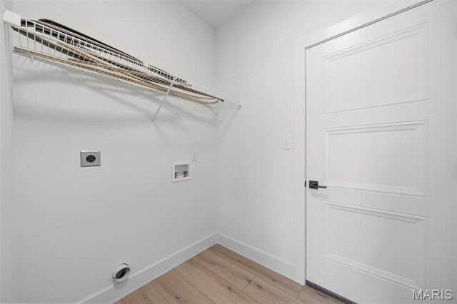 6345 Gibison Rd, Troy, MO 63379 - laundry area featuring hookup for an electric dryer, light wood-type flooring, hookup for a washing machine, and baseboards