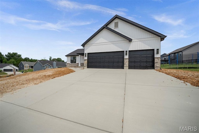 6345 Gibison Rd, Troy, MO 63379 - view of front of home with stone siding, driveway, and a garage