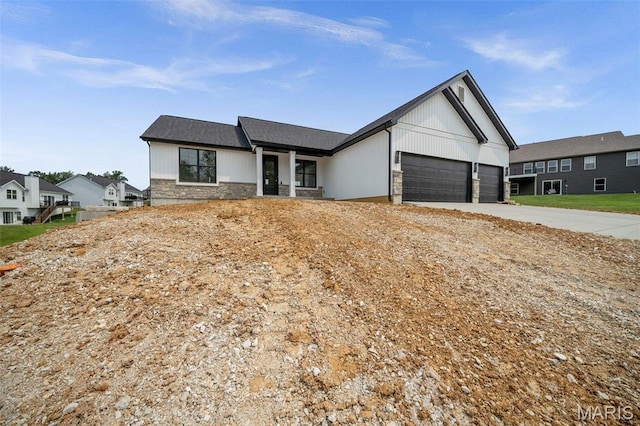 6345 Gibison Rd, Troy, MO 63379 - view of front of house featuring a garage, stone siding, and driveway