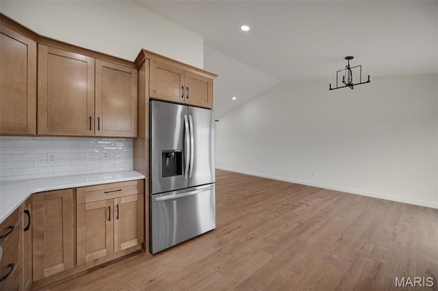 10204 Riehl Farm Dr, Potosi, MO 63664 - kitchen with stainless steel fridge with ice dispenser, tasteful backsplash, light wood-style floors, light countertops, and vaulted ceiling