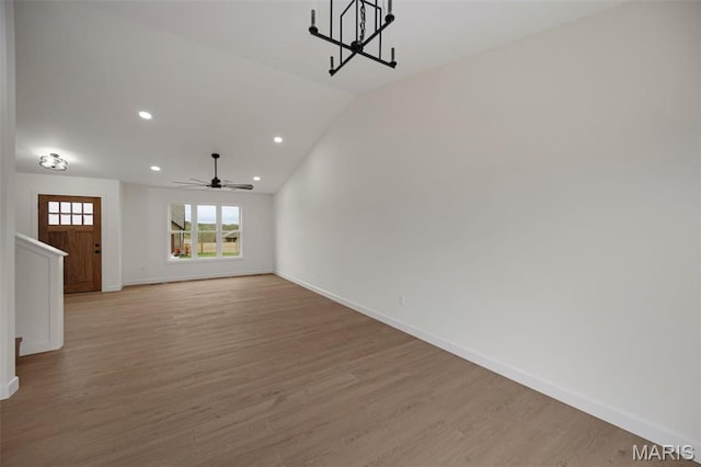 10204 Riehl Farm Dr, Potosi, MO 63664 - unfurnished living room with light wood finished floors, a ceiling fan, a chandelier, stairs, and recessed lighting