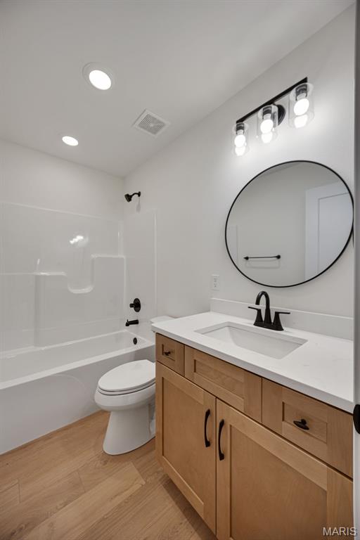 10204 Riehl Farm Dr, Potosi, MO 63664 - full bathroom featuring vanity, wood finished floors, washtub / shower combination, and recessed lighting