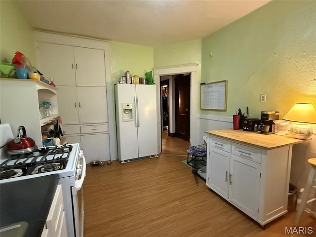 3225 N Taylor Ave, Saint Louis, MO 63115 - kitchen with white appliances, wood finished floors, wood counters, and white cabinetry
