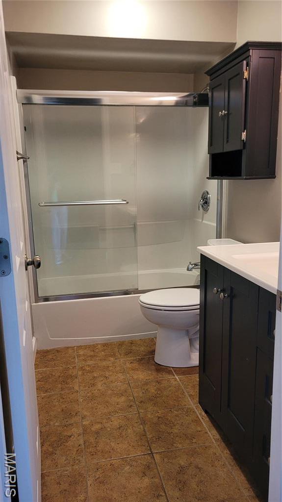 12859 Town And Four Dr Unit 12859, Creve Coeur, MO 63141 - full bathroom with combined bath / shower with glass door, toilet, tile patterned floors, and vanity