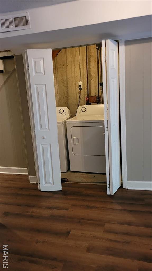 12859 Town And Four Dr Unit 12859, Creve Coeur, MO 63141 - washroom featuring washing machine and clothes dryer, dark wood-style floors, and baseboards