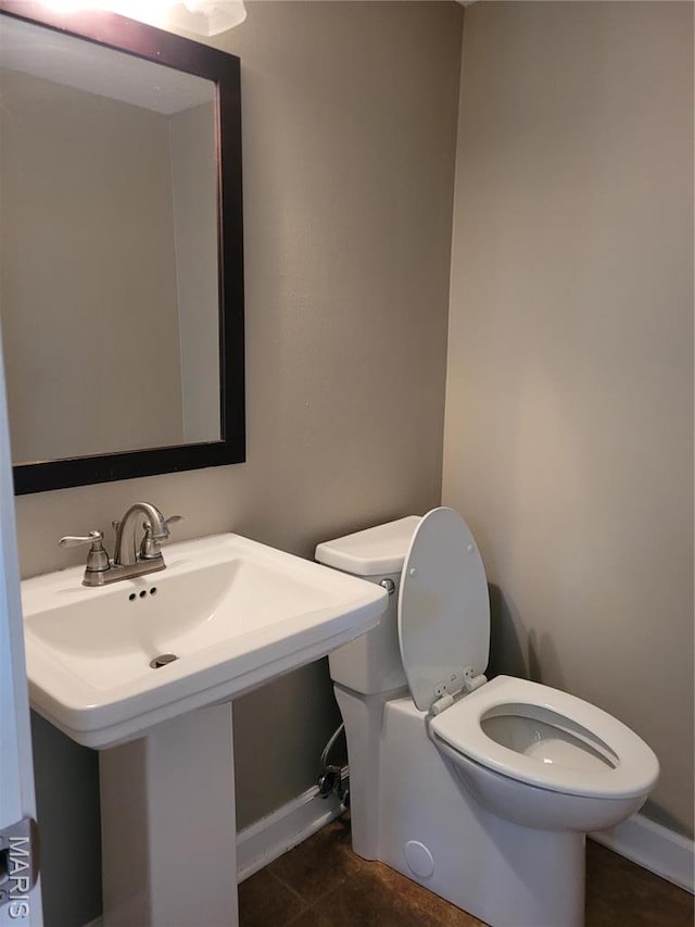 12859 Town And Four Dr Unit 12859, Creve Coeur, MO 63141 - bathroom featuring toilet, baseboards, and a sink