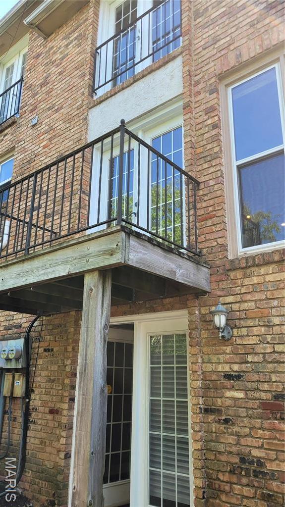 12859 Town And Four Dr Unit 12859, Creve Coeur, MO 63141 - view of home's exterior featuring brick siding and a balcony