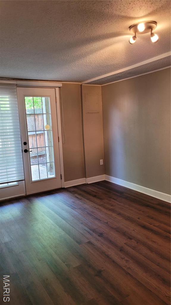 12859 Town And Four Dr Unit 12859, Creve Coeur, MO 63141 - unfurnished room with a textured ceiling, dark wood-type flooring, and baseboards