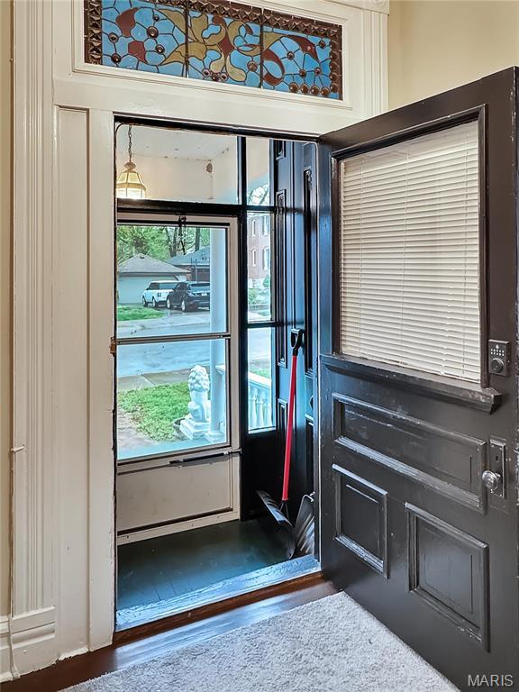 doorway with dark wood-style floors