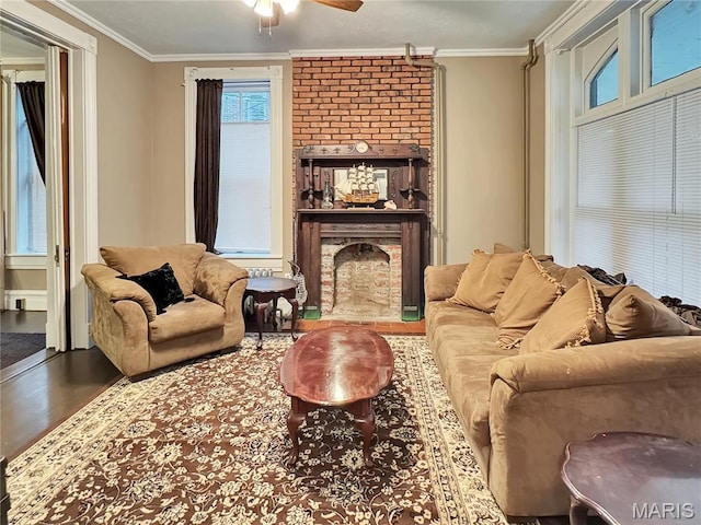 405 Cedar St, Washington, MO 63090 - living room with wood finished floors, ornamental molding, ceiling fan, and a brick fireplace