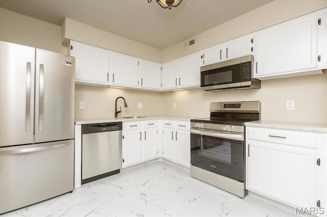 149 Jubilee Hill Dr Unit H, Grover, MO 63040 - kitchen featuring stainless steel appliances, a sink, light marble finish flooring, and light countertops