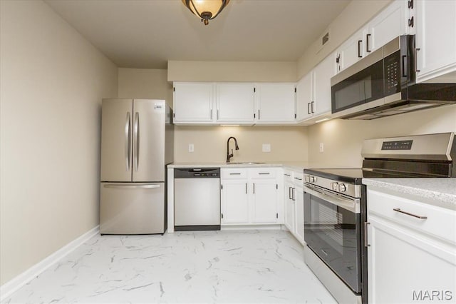 149 Jubilee Hill Dr Unit H, Grover, MO 63040 - kitchen featuring appliances with stainless steel finishes, light marble finish flooring, a sink, and white cabinets