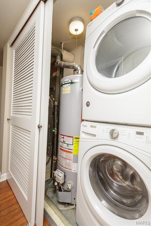 149 Jubilee Hill Dr Unit H, Grover, MO 63040 - laundry area featuring stacked washing machine and dryer, water heater, and wood finished floors