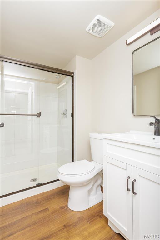 149 Jubilee Hill Dr Unit H, Grover, MO 63040 - bathroom with toilet, vanity, a shower stall, and wood finished floors