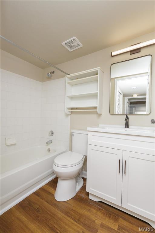 149 Jubilee Hill Dr Unit H, Grover, MO 63040 - bathroom featuring vanity, toilet, tub / shower combination, and wood finished floors