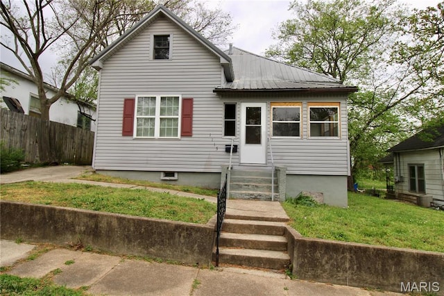 view of front of property with entry steps and metal roof