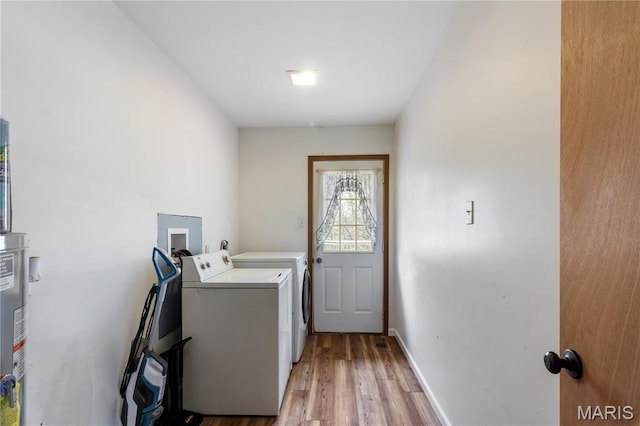 14276 State Route 21, De Soto, MO 63020 - washroom featuring independent washer and dryer, light wood finished floors, baseboards, and water heater