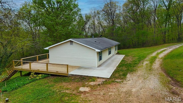 14276 State Route 21, De Soto, MO 63020 - view of side of home featuring a wooden deck, a yard, a forest view, and a patio